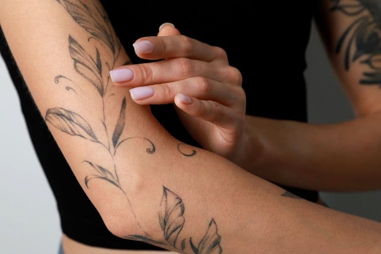 Fine line floral tattoo on an arm