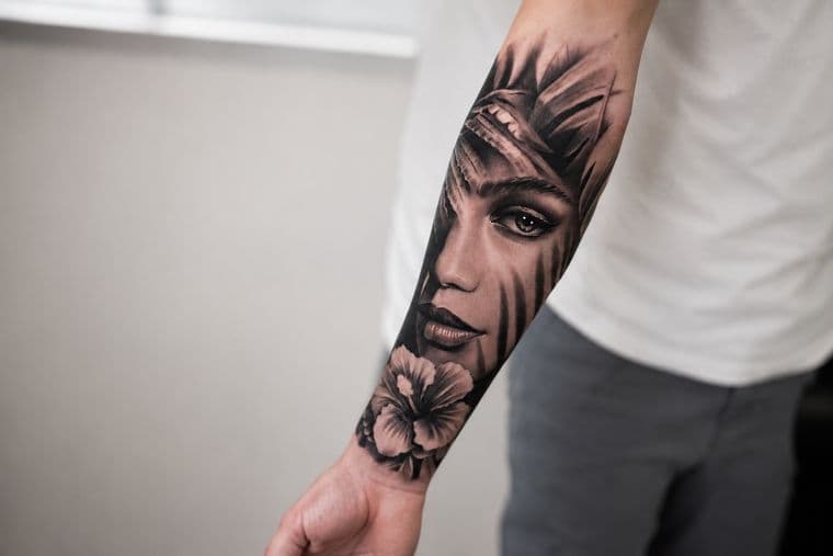 Black and grey realism portrait tattoo on a forearm